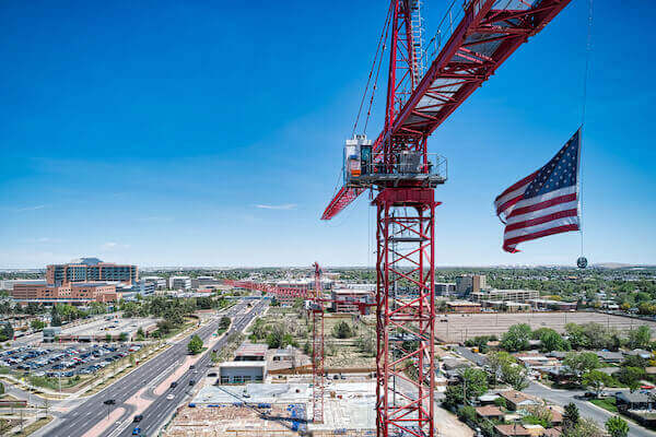 A crane with Aurora, CO in the background.